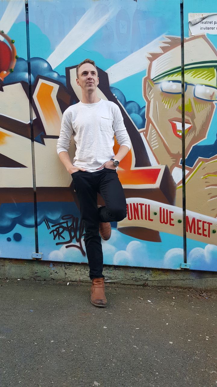 Kristofer DeYoung against a painted wall