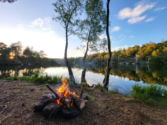A fire, a lake, and the last light of a Swedish June
