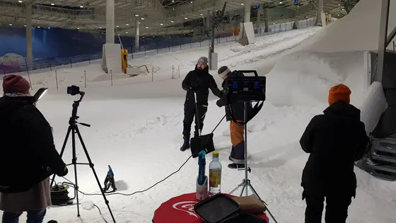 A film crew, in snow, at work