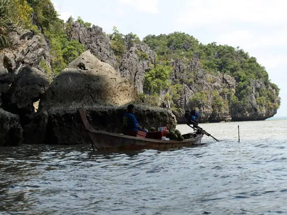 Limestone cliffs, and a boat with an enormous engine